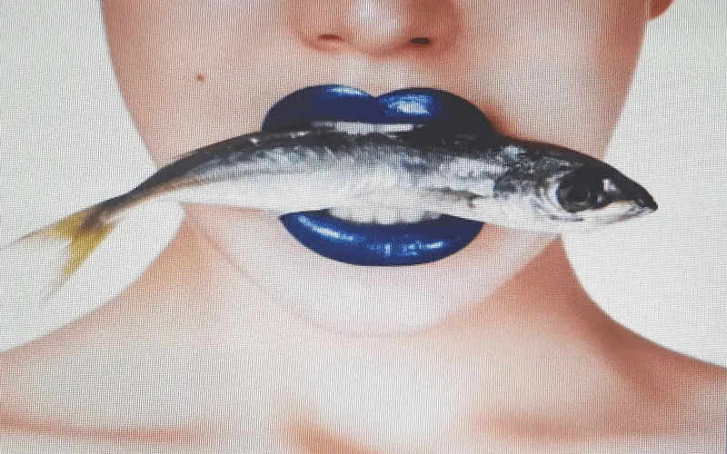 Woman holding omega-3 supplement